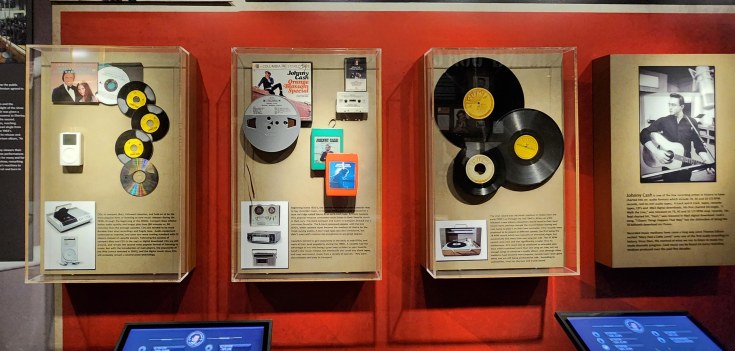 Exhibit panel in the Johnny Cash Museum shows the progression of music medium from reel-to-reel tapes, 8-tracks, cassettes, CDs, to digital throughout the artists’ career.
